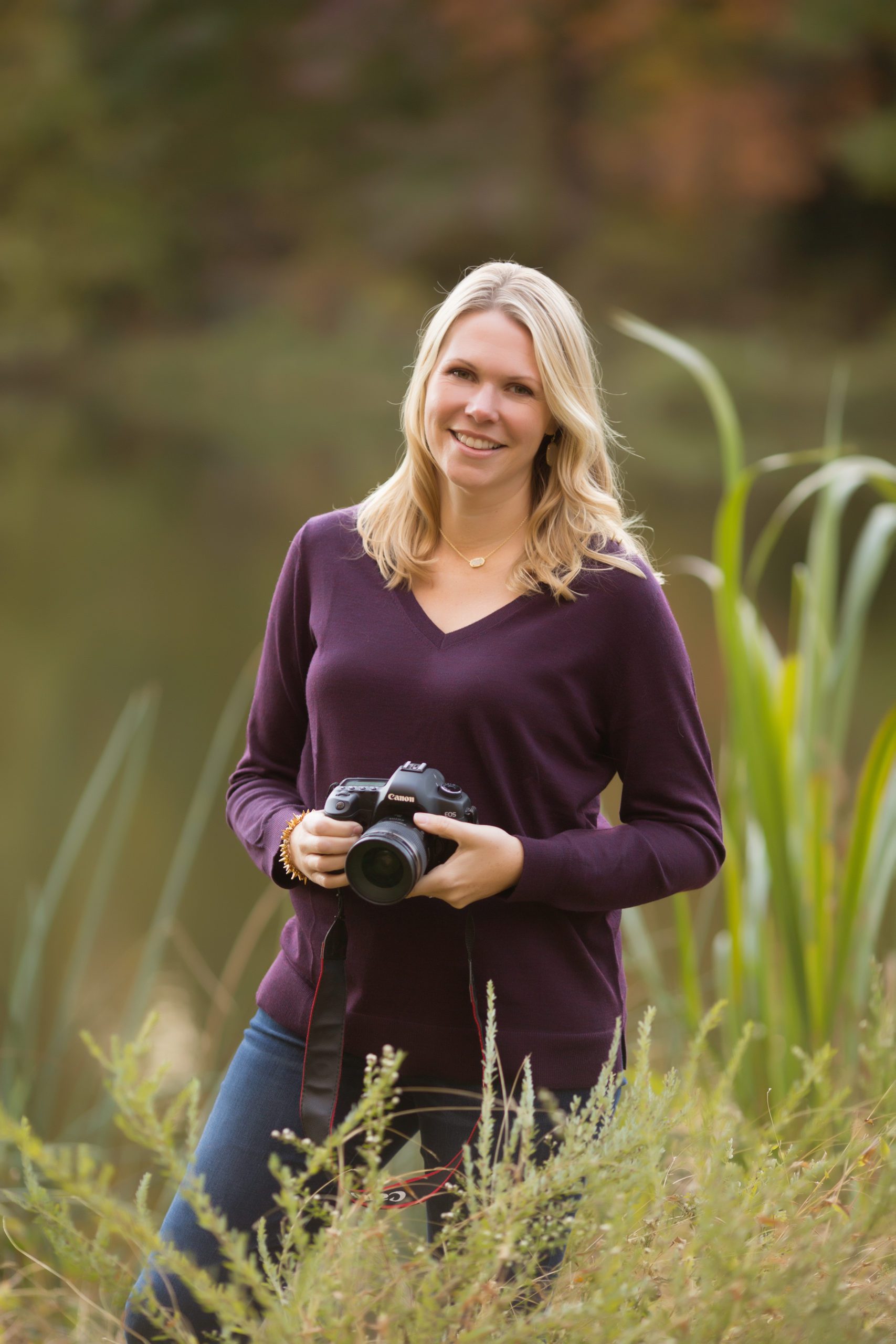 Portrait of Marian Lozano, Northern Virginia family photographer, smiling outdoors in natural light with a soft background, showcasing her warm and approachable personality.